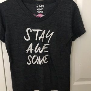 A So Nikki graphic tee that says “Stay Awesome”